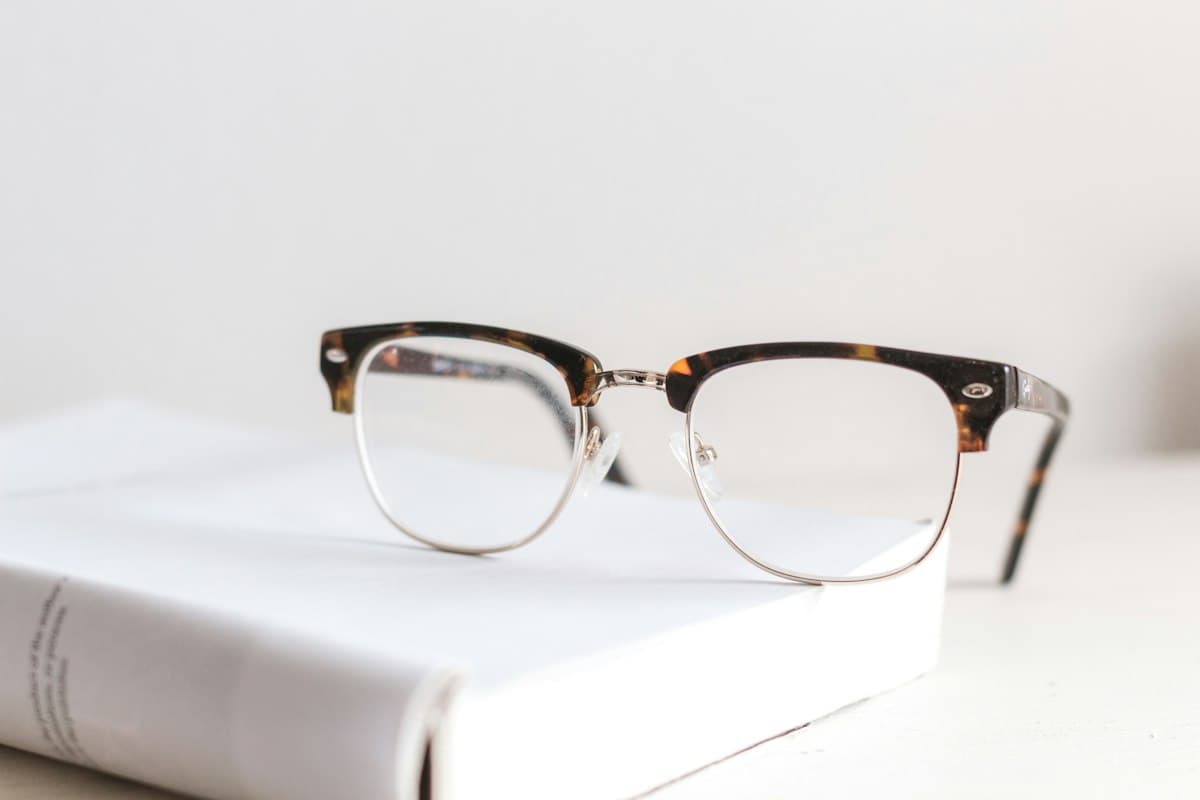 Browline eyeglasses resting on a book